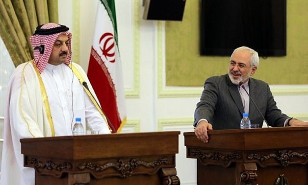 Qatar's Foreign Minister Khalid al-Attiyah (left) holds a joint press conference with his Iranian counterpart Mohammad Javad Zarif on February 26, 2014 in Tehran. (photo credit: AFP/Atta Kenare)
