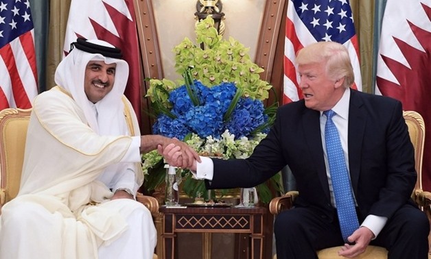 The Qatari emir Sheikh Tamim Bin Hamad Al Thani shakes hands with US president Donald Trump during a bilateral meeting in the Saudi capital Riyadh on May 21, 2017. Mandel Ngan / AFP
