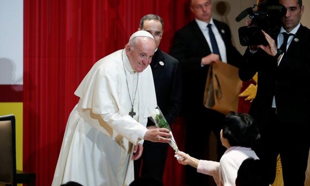 Pope Francis receives a flower after giving a speech at Sophia University in Tokyo, Japan November 26, 2019. REUTERS/Kim Hong-Ji/Pool
