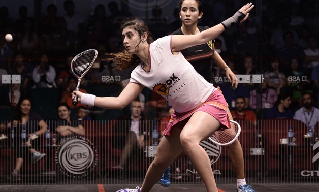 Nour El Sherbini of Egypt (L) plays a forehand against her compatriot Nouran Gohar (R) during their semi-final match of the PSA Women's World Championships squash tournament in Bukit Jalil, oustide Kuala Lumpur on April 29, 2016. / AFP PHOTO / MOHD RASFAN