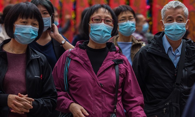 People wearing masks visit Wong Tai Sin temple on the first day of the Lunar New Year of the Rat in Hong Kong on January 25, 2020, as a preventative measure following a coronavirus outbreak which began in the Chinese city of Wuhan. Hong Kong on January 25