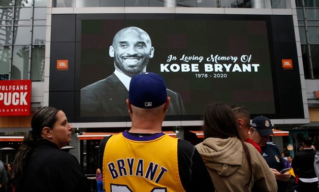 Kobe Bryant on screen in public square - file