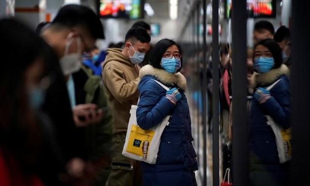 People wearing masks are seen at a subway station in Shanghai, China January 23, 2020. REUTERS/Aly Song
