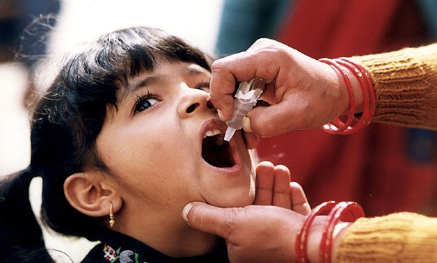 Girl receiving oral polio vaccine- CC via/CDC Global
