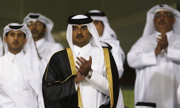 Qatar's Crown Prince Sheikh Tamim bin Hamad al-Thani (C) arrives at Al-Sadd Stadium for the final Crown Prince Cup soccer match between Qatari teams Al-Sadd and Lekhwaiya in Doha May 4, 2013. REUTERS/Fadi Al-Assaad