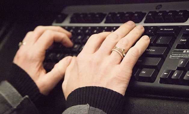 Person typing on a computer keyboard – Flickr/Wellness Corporate Solutions