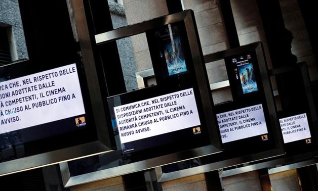 FILE PHOTO - Screens next to a cinema display a message explaining that the cinema will remain closed following a decision taken by authorities in Milan, Italy, March 4, 2020. REUTERS/Guglielmo Mangiapane.