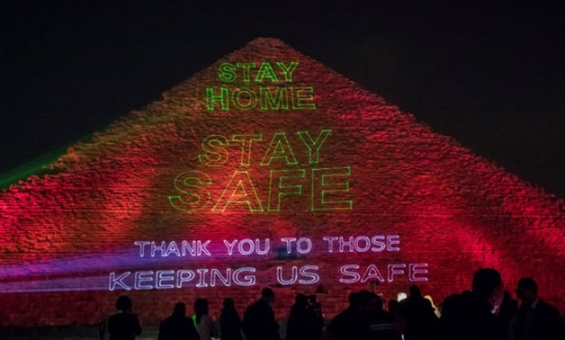 File-Great Pyramid of Giza lit up with coronavirus messages .