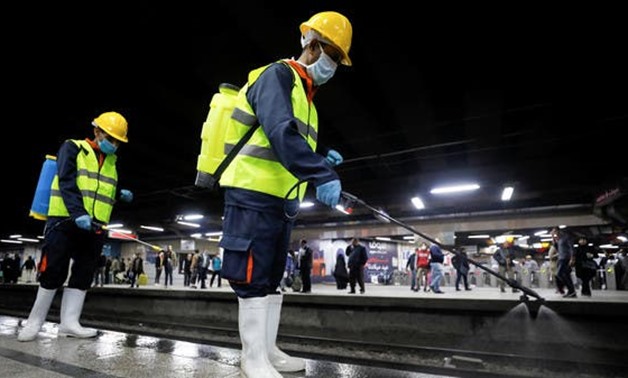 A member of medical team sprays disinfectant at the underground Al Shohadaa Martyrs metro station in Cairo. (File photo: Reuters)