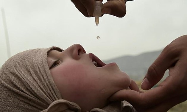 File- Thee new cases of polio have been recorded in Syria, the WHO says, blaming under-immunisation in the war-wracked country. Vaccination -- like this in Afghanistan -- is simple and relatively cheap