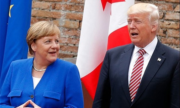 German Chancellor Angela Merkel and US President Donald Trump as they attend the Summit of the Heads of State and of Government of the G7 – AFP/Philippe Wojazer