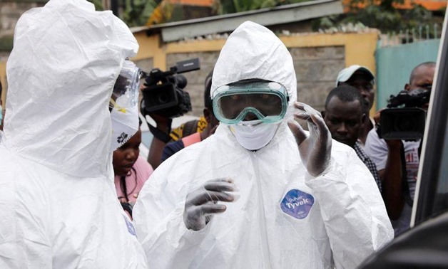 FILE - Kenyan health workers dressed in protective suits prepare to disinfect the residence where Kenya's first confirmed coronavirus patient was staying, in the town of Rongai near Nairobi, Kenya March 14, 2020. REUTERS/Baz Ratner
