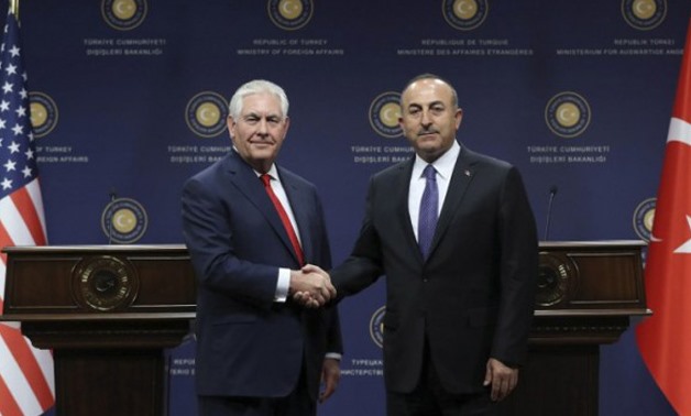US Secretary of State Rex Tillerson, left, Turkish Foreign Minister Mevlut Cavusoglu shakes hands during a joint news conference in Ankara, March 30, 2017 - AFP