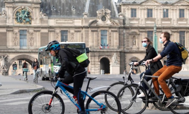 FILE PHOTO: Bikers ride past the Louvre museum after France began a gradual end to a nationwide lockdown due to the coronavirus disease (COVID-19), in Paris, France, May 13, 2020. REUTERS/Charles Platiau