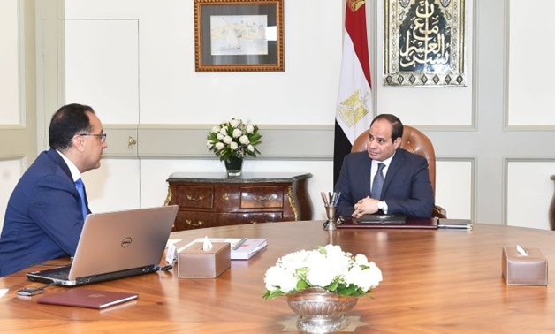 FILE – Egypt’s President Abdel Fattah El-Sisi (R) meets with Prime Minister Mustafa Madbouli (L)