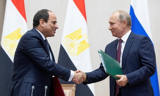 Russian President Vladimir Putin and Egyptian President Abdel Fattah el Sisi shake hands during a signing ceremony following their meeting in the Black Sea resort of Sochi - Reuters