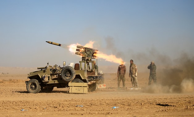 FILE PHOTO: Shi'ite fighters fire a rocket towards Islamic State militants during a battle with Islamic State militants at the airport of Tal Afar, west of Mosul, Iraq, November 18, 2016. REUTERS/Thaier Al-Sudani/File Photo. To match Special Report IRAQ-I