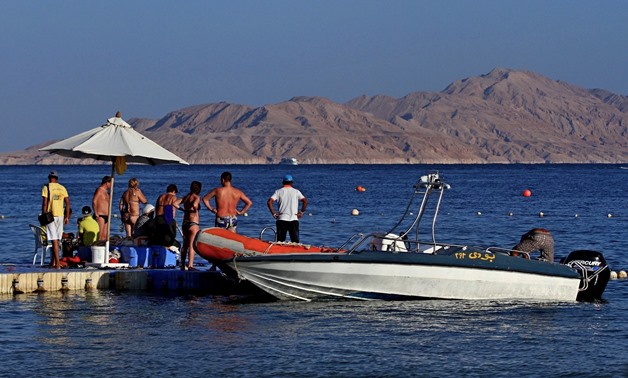  A picture taken on November 12, 2015 from the Egyptian Red Sea resort of Sharm el-Sheikh shows tourists preparing to board a boat in front the Tiran island./ AFP PHOTO / STRINGER