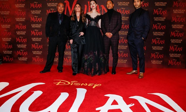 FILE PHOTO: Cast members Ron Yuan, Yifei Liu, Jason Scott Lee and Yoson An pose with director Niki Caro, at the European premiere for the film "Mulan" in London, Britain March 12, 2020. REUTERS/Henry Nicholls/File Photo.