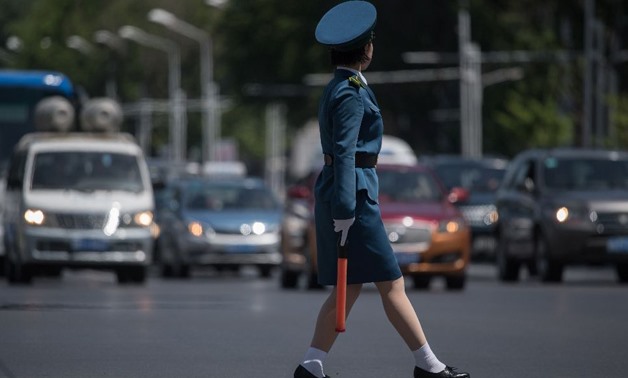 Officially known as traffic security officers but universally referred to as traffic ladies, they are chosen for their looks in a society that remains traditionalist in many respect - AFP 