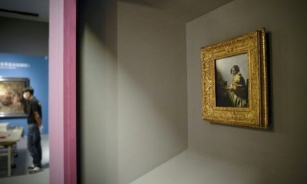 Johannes Vermeer's "Young Woman Seated at a Virginal" is displayed as part of the Masterpieces from The Leiden Collection exhibition at China's National Museum in Beijing.-AFP
