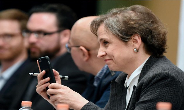Mexican journalist Carmen Aristegui holds her mobile phone during a press conference in Mexico City, on June 19, 2017