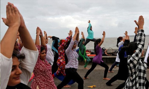 Participants practice yoga on International Yoga Day on a seafront promenade in Mumbai, India Wednesday. Shailesh Andrade, Reuters