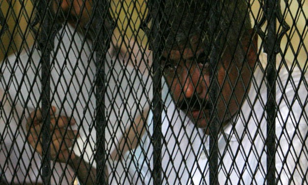 Hesham Talaat Moustafa, former chairman of the Talaat Moustafa Group, stands inside a cage at a court in Cairo, Egypt June 25, 2009. REUTERS/Asmaa Waguih/File Photo.