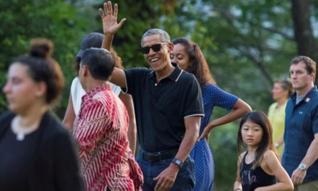Former President Barack Obama (C) waves while walking with his daughter Malia during a visit to the 9th-century Borobudur Temple in Magelang, Central Java, Indonesia June 28, 2017. REUTERS/Pius Erlangga
