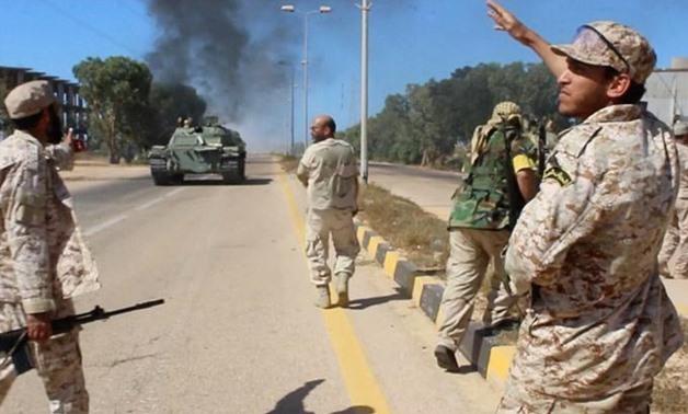 Soldiers from a force aligned with Libya's new unity government walk along a road during an advance on the eastern and southern outskirts of the Islamic State stronghold of Sirte, in this still image taken from video on June 9, 2016. via Reuters TV