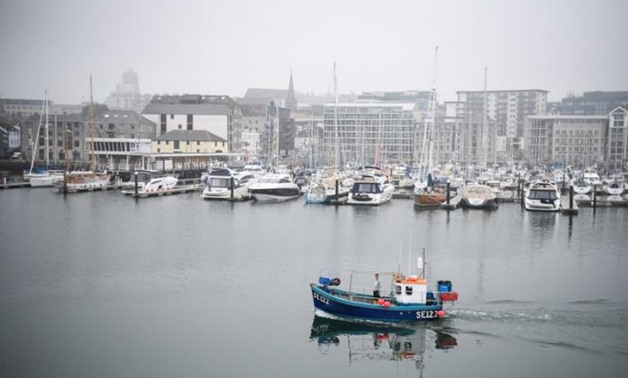FILE PHOTO: A fishing boat sails from the harbour as as Britain's Prime Minister Theresa May visits Plymouth fisheries, in Plymouth, May 31, 2017. REUTERS/Leon Neal/Pool/File Photo