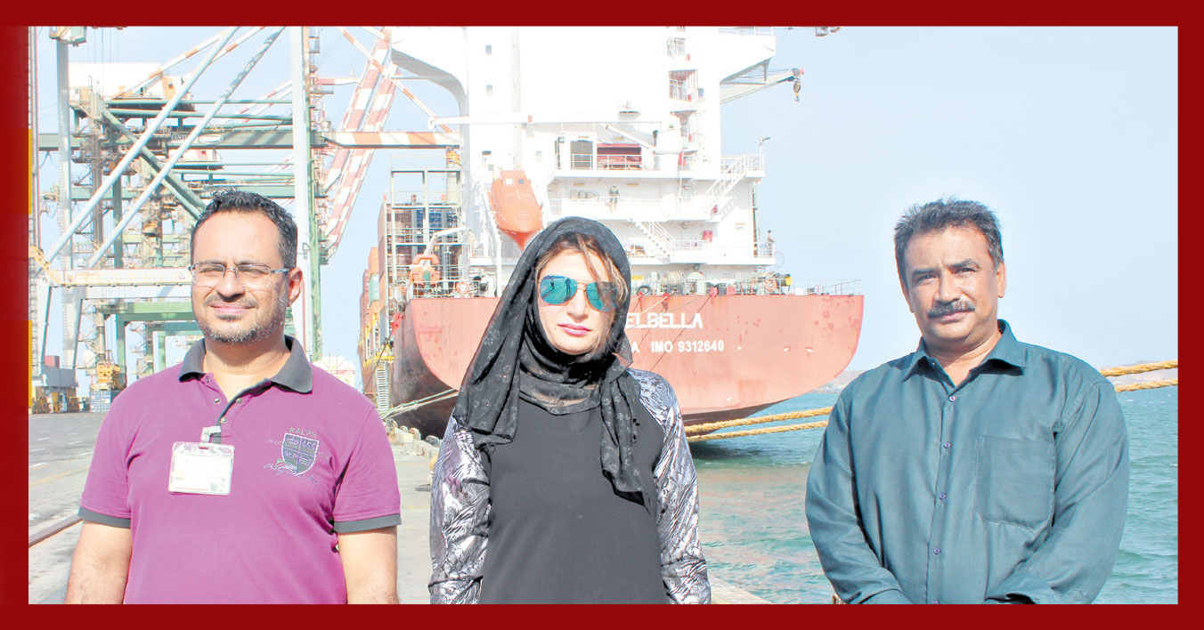 Workers inside the port of Aden with the reporter