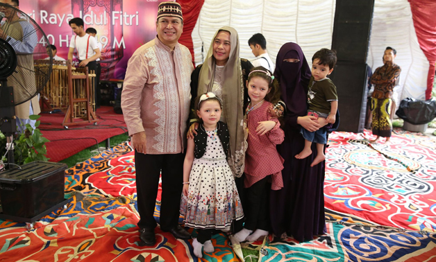 Mr Ambassador and his wife pose for a picture with Indonesian people- press photo